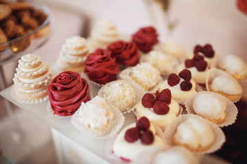 Cookies covered with red and white icing served on the table