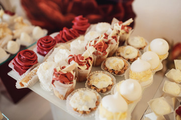 Cookies covered with red and white icing served on the table