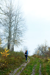 Naklejka na ściany i meble Woman hiker on the autumn nature