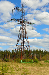 Electrical transmission pylon in the field. High voltage. Blue sky background. - 158140535