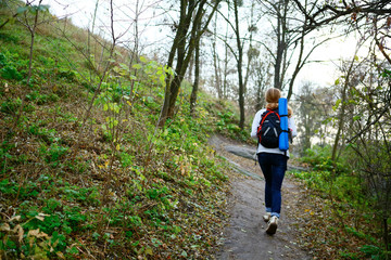 Naklejka na ściany i meble Woman hiker walking the mountain trail in weekend