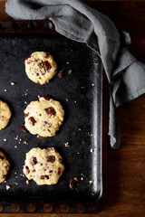 Cookies with chocolate on a baking tray
