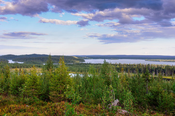 A bright natural landscape in summer season. A view from hill over the forest, bog and lakes in northern Finland. - 158140922