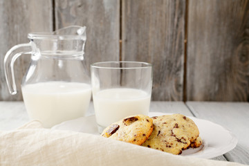 Cookies with milk on wooden background