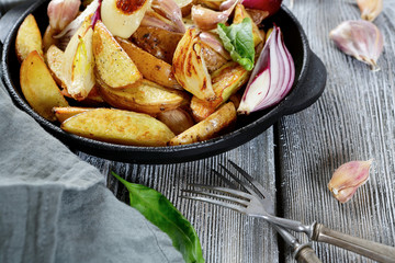 Crispy baked potatoes in a pan