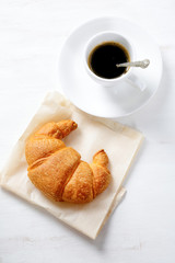Delicious croissant with coffee