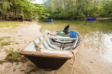 Obraz premium The small boat parked in a small canal at the mangrove forest.Thailand.