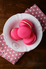 Delicious strawberry macaroon in a white plate