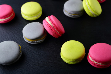 Assorted Sweet colorful macaroon on slate background