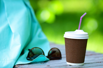 Disposable Coffee cup and Sunglasses on outdoors
