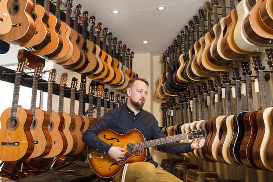 Man playing guitar in shop