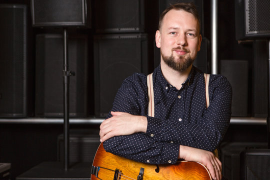 Guitarist sitting on guitar combo