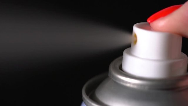 Closeup of bottle spraying on the black background