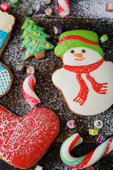 Fototapeta na wymiar Christmas ginger cookies and sweet candy strewn with snow