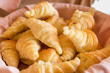 Fresh croissants in the basket for breakfast.