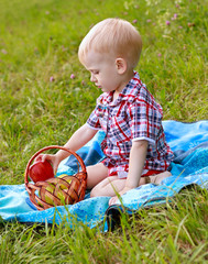 Child having picnic on the green meadow
