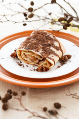 Apple pie strewn grated chocolate and decorated of dry branch