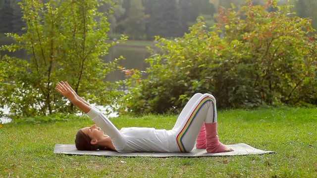 Video of outdoor fitness training of young beautiful woman doing exercise for arms and brest