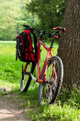 Bike and backpack among the green of nature in spring