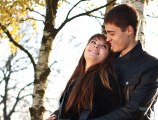 Happy young couple in love having fun autumn park