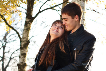 Happy young couple in love having fun autumn park