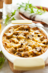 Vegetables casserole with mushrooms, potatoes and cheese closeup