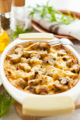 Vegetables gratin with mushrooms, potatoes and cheese on a pan