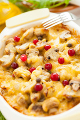 Baked vegetables. Mushrooms, potatoes, cranberries and cheese on a pan