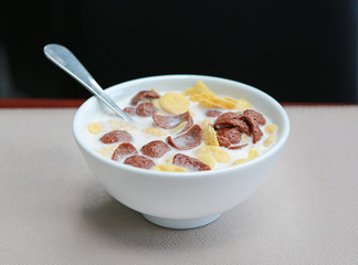 Cornflakes cereal and milk in a bowl. Morning breakfast.