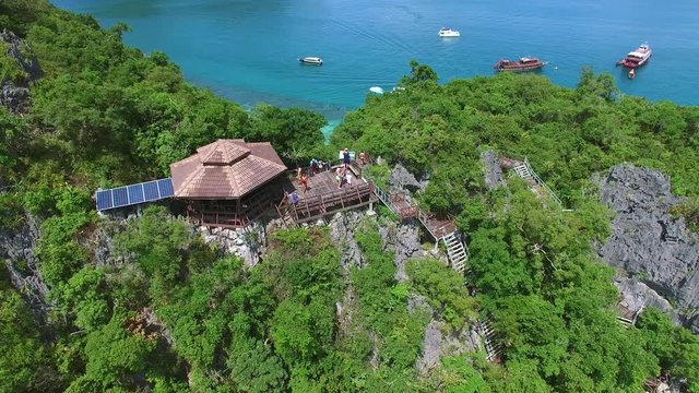 Aerial: Tourists On View Point In Jungle Surrounded By Turquoise Sea. 4K. 