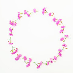 Fototapeta na wymiar Floral round frame made of pink flowers on white background. Flat lay, top view. Floral pattern