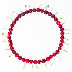 Food round frame of tasty cherries on white background. Flat lay. Top view. Summer concept