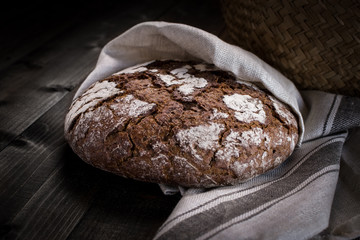 Traditional Whole Grain Rye Bread on Dark Wooden Table Background