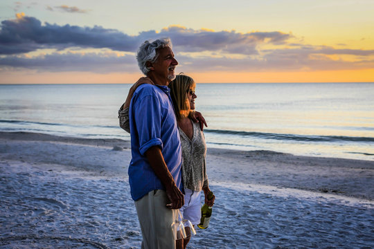 Active retirees enjoy the sunset on Siesta Key beach FL