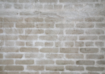 The background of the plastered wall. Plastered brick wall with white silhouettes of bricks.