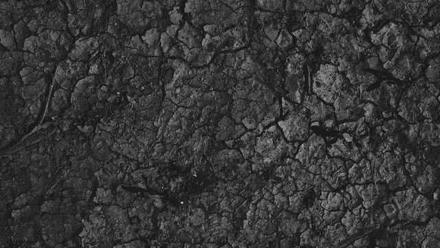 Pure environmental textured pattern abstract art in neutral color overhead shot. Forgotten dirty stones short loop in low light. Elegant retro design in high contrast minimal style. 
