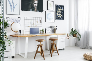 Double desk and two stools in home office