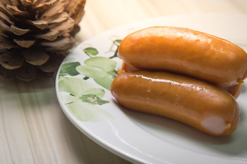  Pork sausage on wood table image closeup