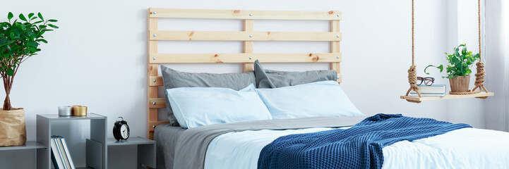 Fototapeta na wymiar Wooden bed in bedroom