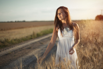 Beautiful woman in wheat meadow