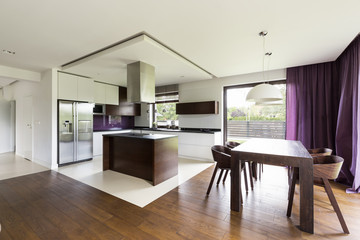 Modern open kitchen with wooden table