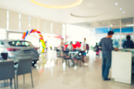 Blurred Photo Of Car Showroom With Customer