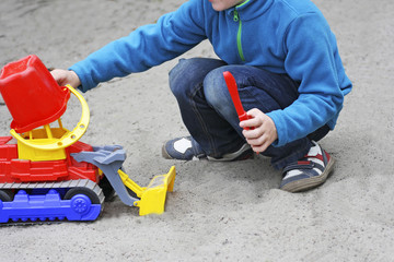 A boy plays with a machine.