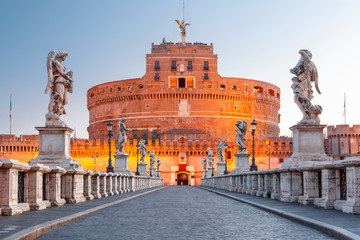 Saint Angel castle and bridge and Saint Peter Cathedral during morning blue hour in Rome, Italy.