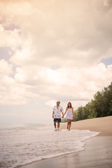 Young couples walking on the beach.