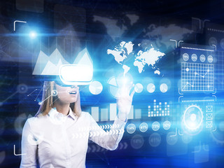 Blond woman in vr glasses in blue room, graphs