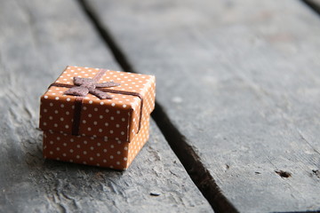 Gift box on white wood table. With a lot of copy space.
