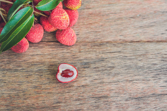 Fresh litchi fruit on an old wooden background