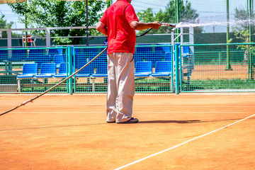 Watering of the ground tennis court with water