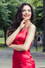 Fototapeta premium beautiful smiling woman in a red dress